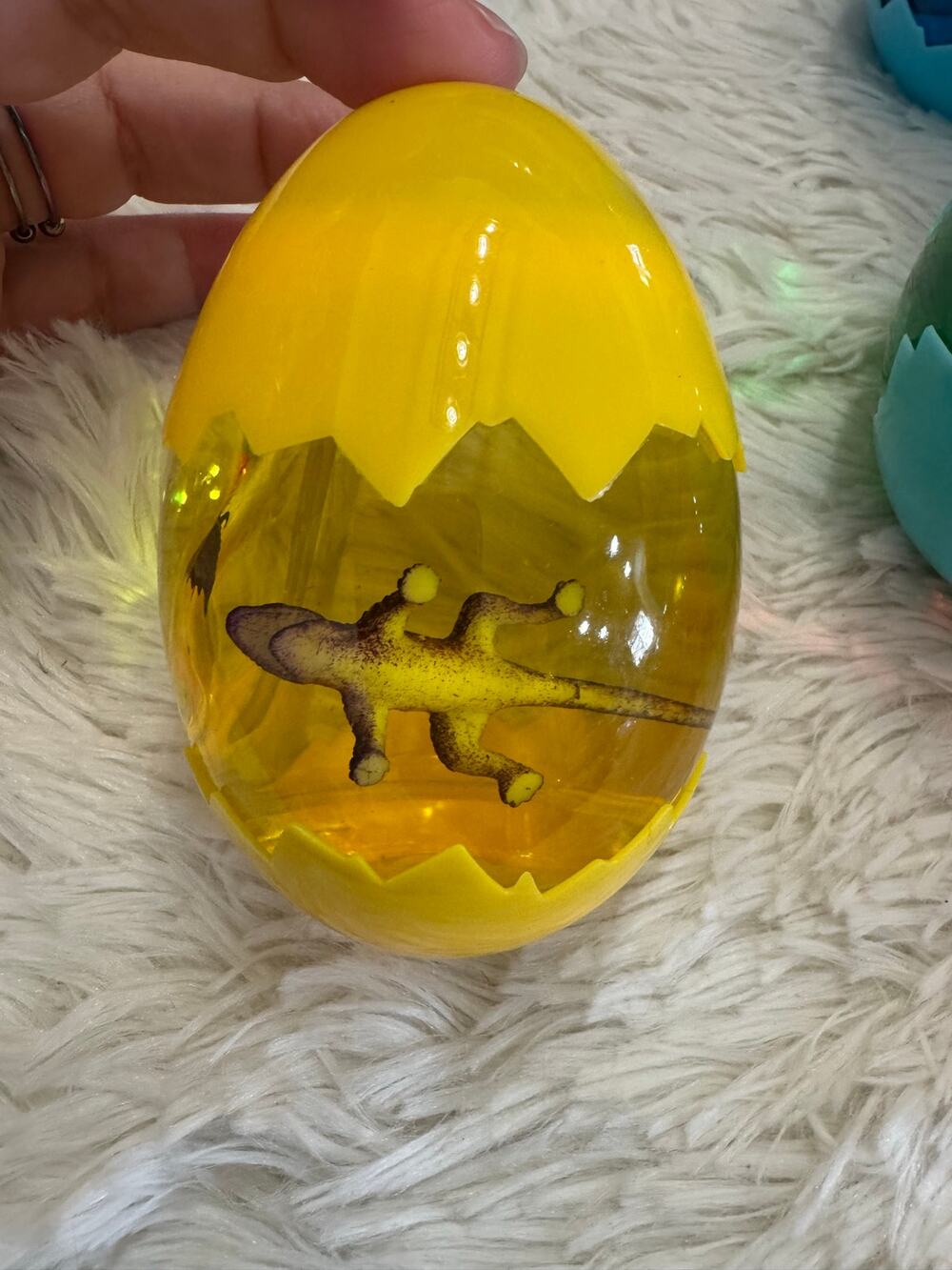 Yellow slime dinosaur egg with a assorted dinosaurs inside